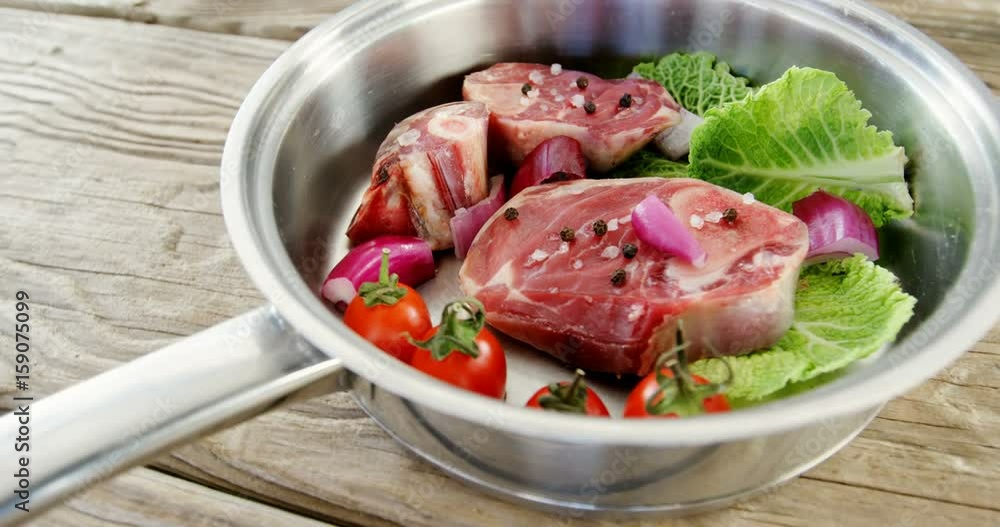 Marinated meat chops and vegetables in the pan Marinated meat chops and vegetables in the pan