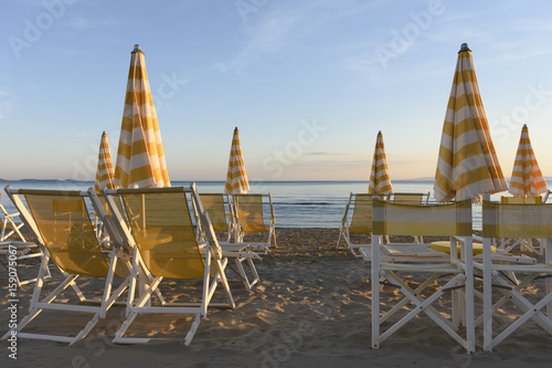 Beach umbrellas and sun loungers ready for the summer season  © Charsy