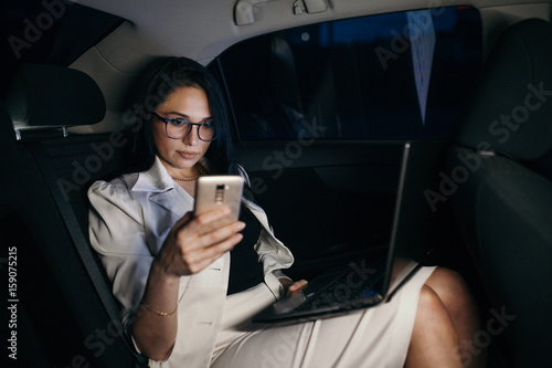 Beautiful business woman sitting in back seat of car © kuzovkov