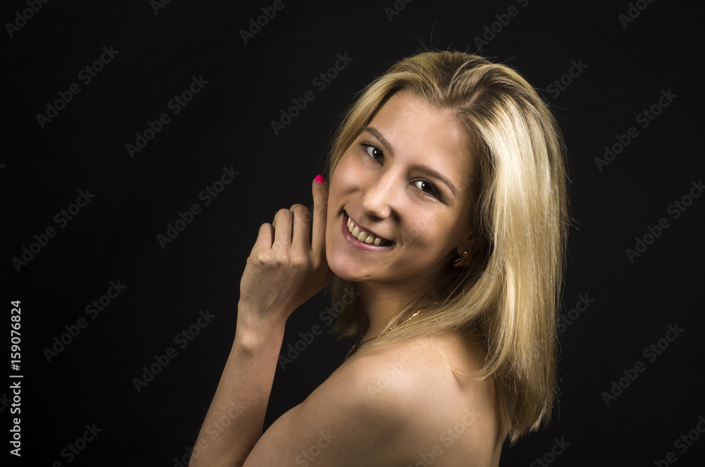 Portrait of a smiling girl on a dark background. Portrait of a smiling girl on a dark background.