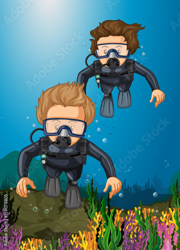 Two divers diving under the ocean