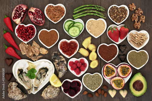 Healthy aphrodisiac food collection to boost sexual health on oak wood background.