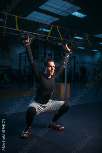 Sportsman on training,endurance workout with ropes