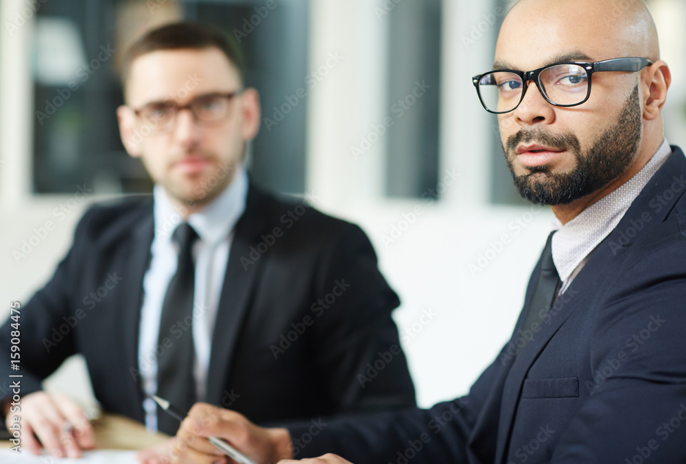 Businessman in eyeglasses looking at camera Businessman in eyeglasses looking at camera