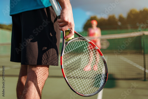 Male and female person playing tennis outdoor