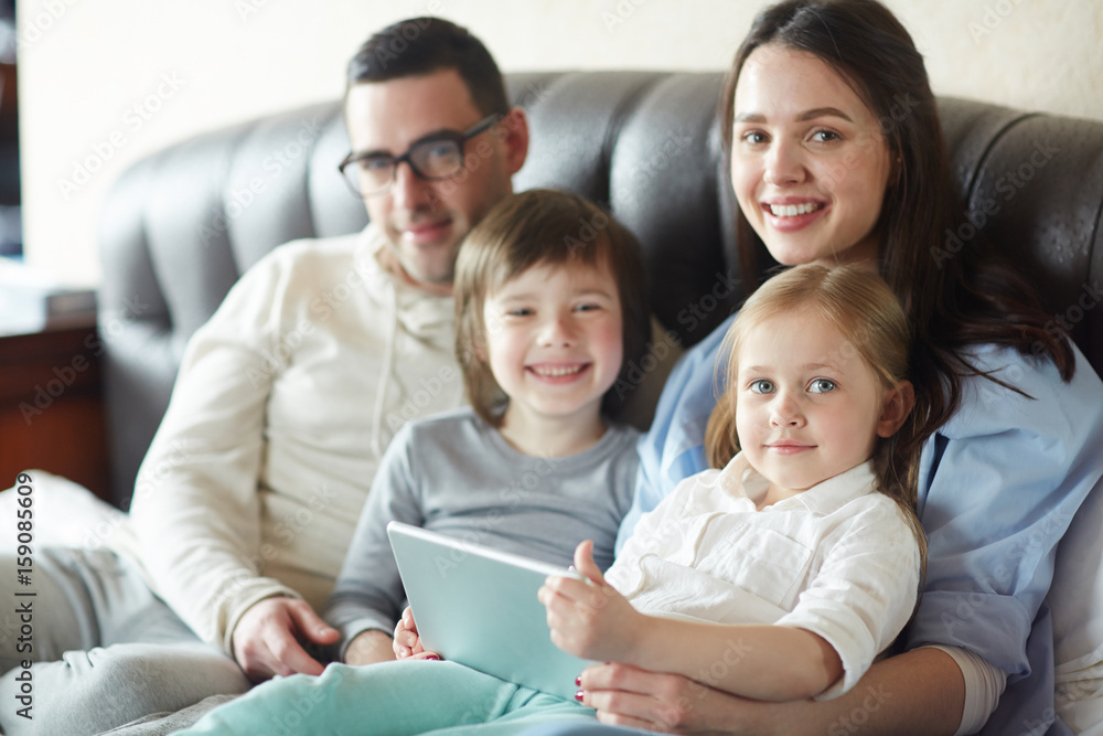 Modern couple and their kids spending leisure in the net Modern couple and their kids spending leisure in the net