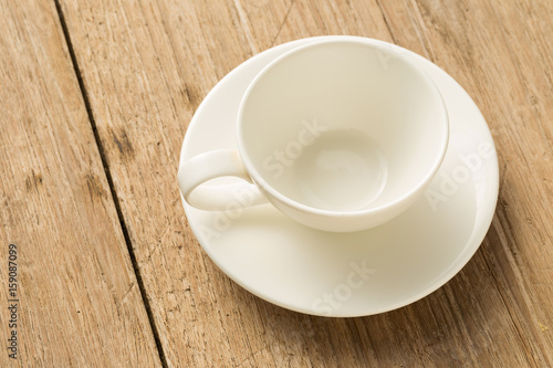 Empty white ceramic coffee mug on wooden background