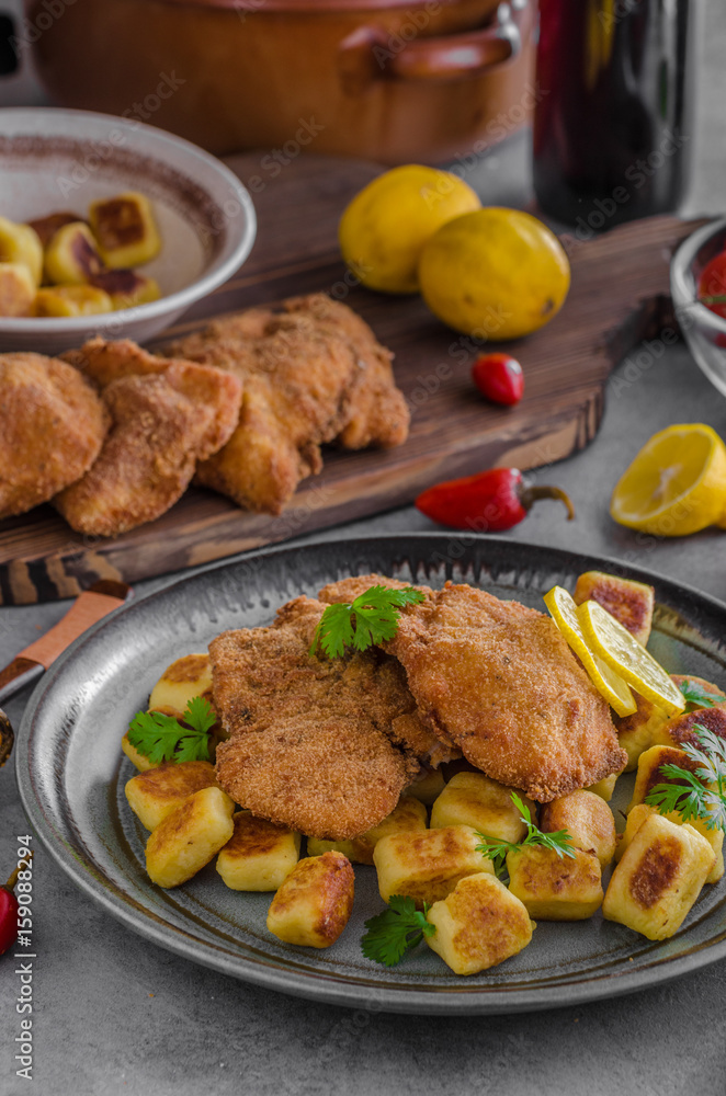 Schnitzel original with lemon and gnocchi fried Schnitzel original with lemon and gnocchi fried