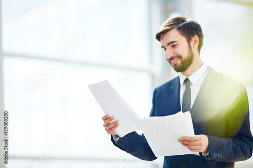 Happy ceo reading papers or contracts