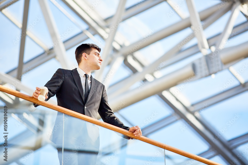 Restful businessman with drink having break Restful businessman with drink having break