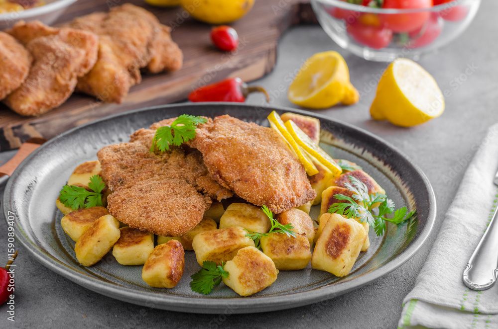 Schnitzel original with lemon and gnocchi fried Schnitzel original with lemon and gnocchi fried