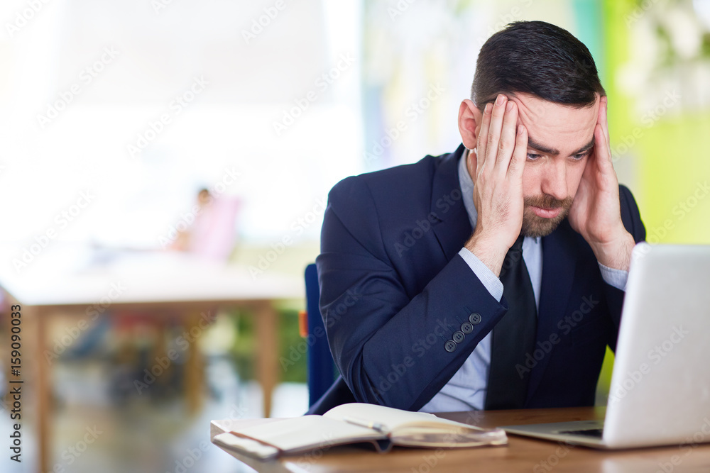 Businessman thinking of ideas in front of laptop Businessman thinking of ideas in front of laptop