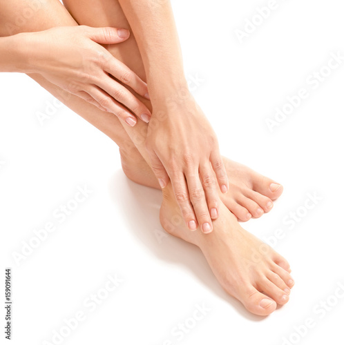 Female hands and legs on white background © Africa Studio