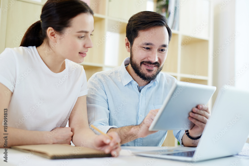 Businesspeople with gadgets browsing in the net and looking for necessary data Businesspeople with gadgets browsing in the net and looking for necessary data