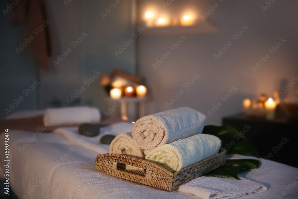 Interior of modern massage room in candle light Interior of modern massage room in candle light