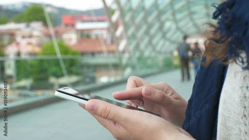 woman using the phone on the background of the business center. Slow motion woman using the phone on the background of the business center. Slow motion