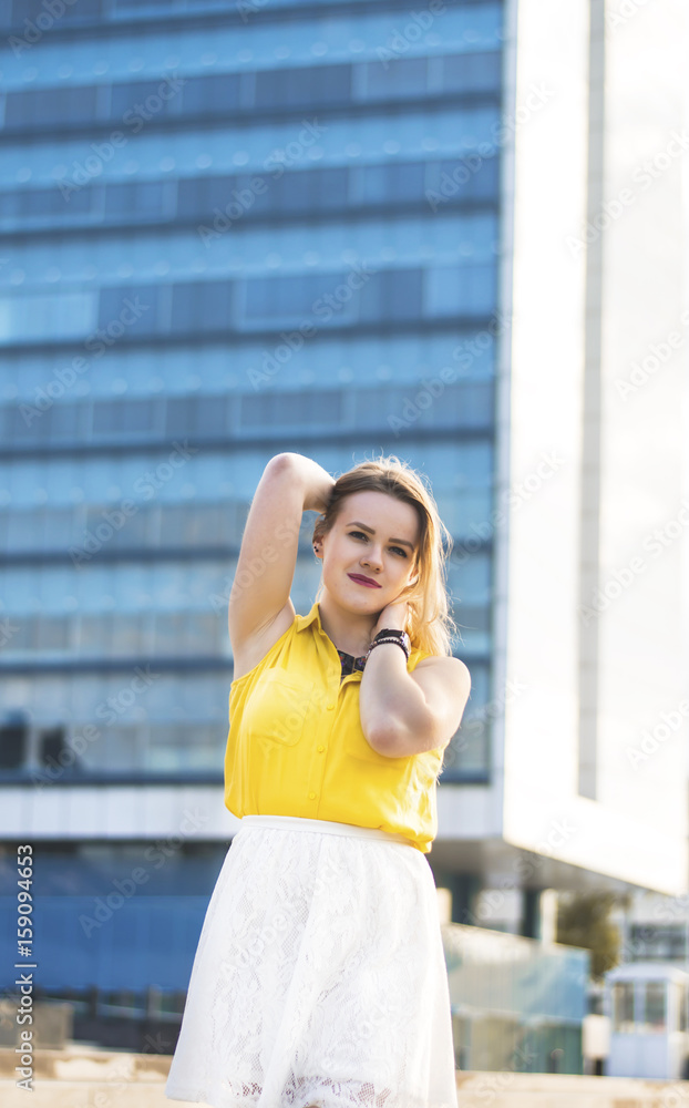 Beautiful young women posing in different clothes in urban surroundings Beautiful young women posing in different clothes in urban surroundings