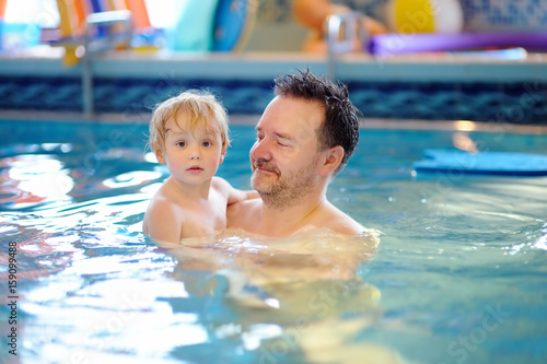 Happy smiling little boy with his father in swimming pool © Maria Sbytova