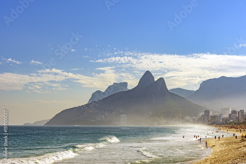 View of Ipanema beach at summer day with mountains in background
