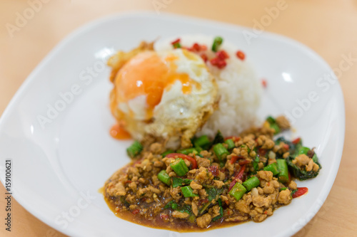 Rice topped with stir-fried pork and basil and fired egg