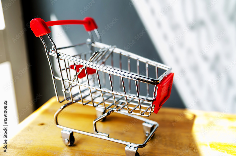 side view of Shopping cart on wood table ,shopping concept side view of Shopping cart on wood table ,shopping concept