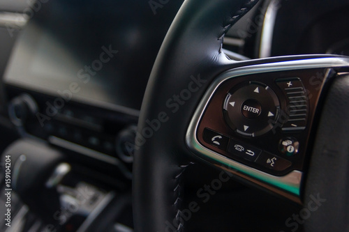 Control buttons on steering wheel, Car interior. © navintar