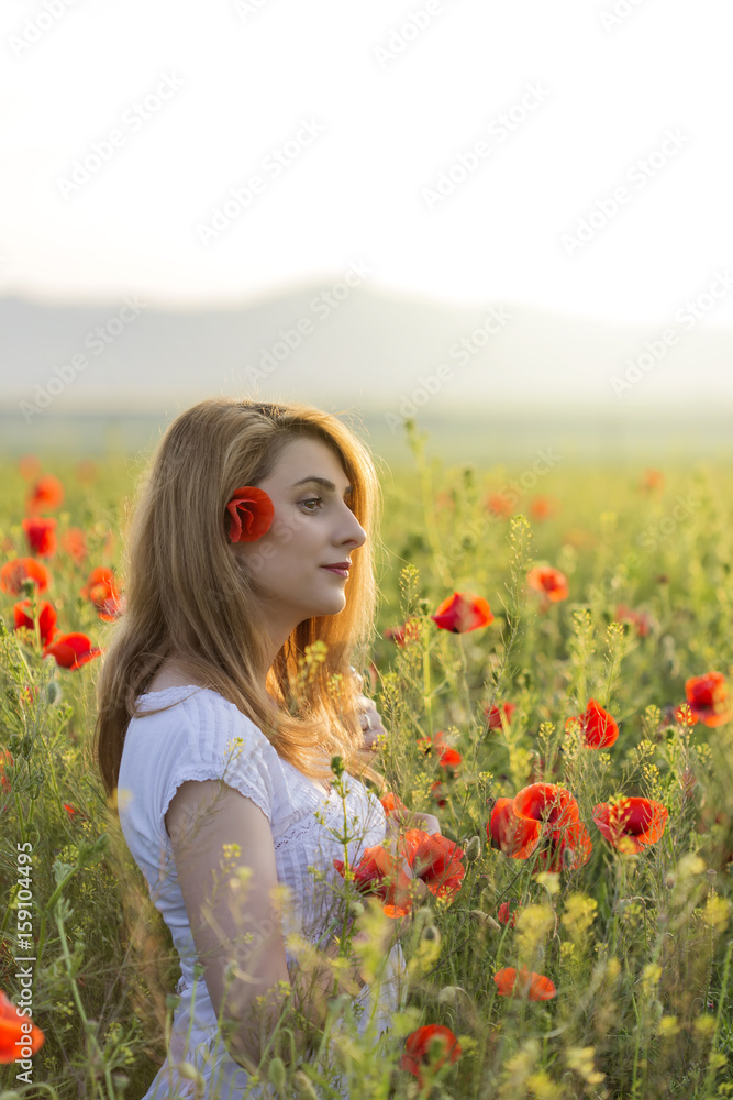 Woman in a full field of poppies Woman in a full field of poppies
