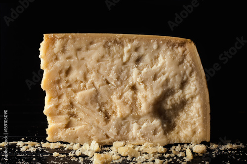 Slice of parmesan cheese with black background