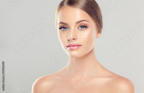 Beautiful Young Woman with Clean Fresh Skin . Facial  treatment   . Cosmetology   beauty  and spa .  