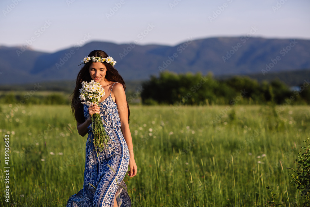 Woman enjoying daisy field, nice female lying down in meadow of flowers, pretty girl relaxing outdoor, having fun, holding plant, happy young lady and spring green nature, harmony concept Woman enjoying daisy field, nice female lying down in meadow of flowers, pretty girl relaxing outdoor, having fun, holding plant, happy young lady and spring green nature, harmony concept