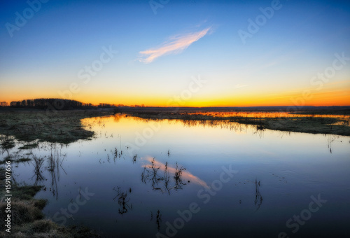 Spring morning. Beautiful dawn near a picturesque river. Colorful foggy dawn