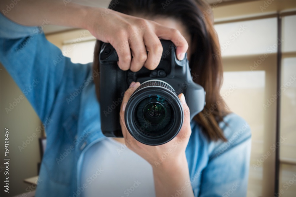 Composite image of young female photographing through camera Composite image of young female photographing through camera