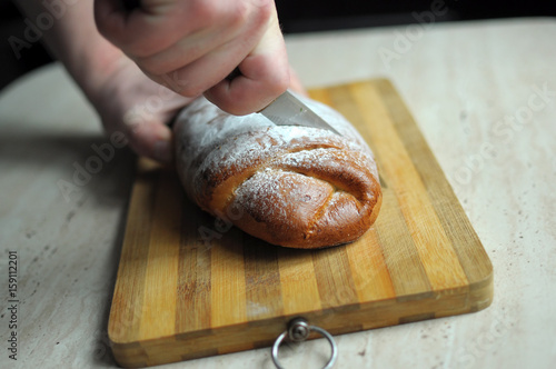 Man hands cutting pineapple pie photo