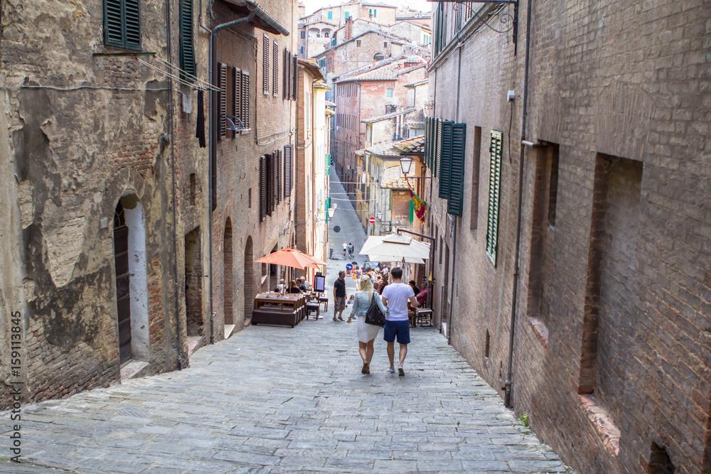 Narrow medieval street in Siena, Italy