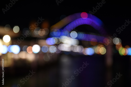 Bokeh with yellow, blue and purple colors, Night city lights background. Blurred Bokeh light vintage background, Abstract colorful defocused dot, Soft focus. Bokeh Sydney Harbour Bridge.