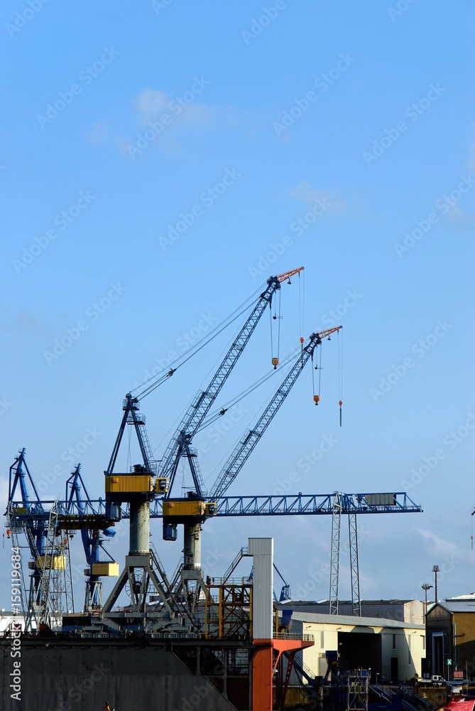 The port of Hamburg with a crane in the background and blue sky