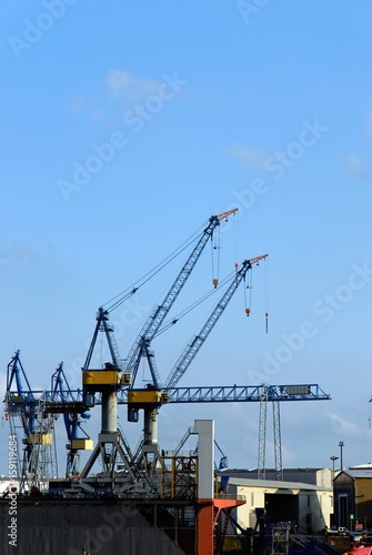 The port of Hamburg with a crane in the background and blue sky