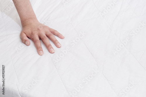 Hand on mattress
