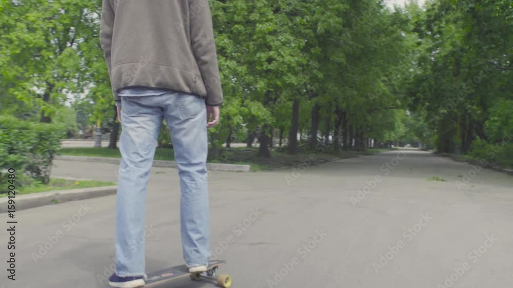 Young man riding on longboard Young man riding on longboard