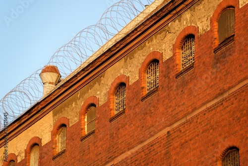 The outside view of an old and abandoned jail in Berlin during sunset photo