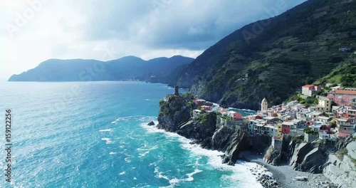 aerial view of travel landmark destination Vernazza, a small mediterranean sea town, Cinque terre National Park, Liguria, Italy. Afternoon sunny and cloud weather. 4k aerial drone forward video shot