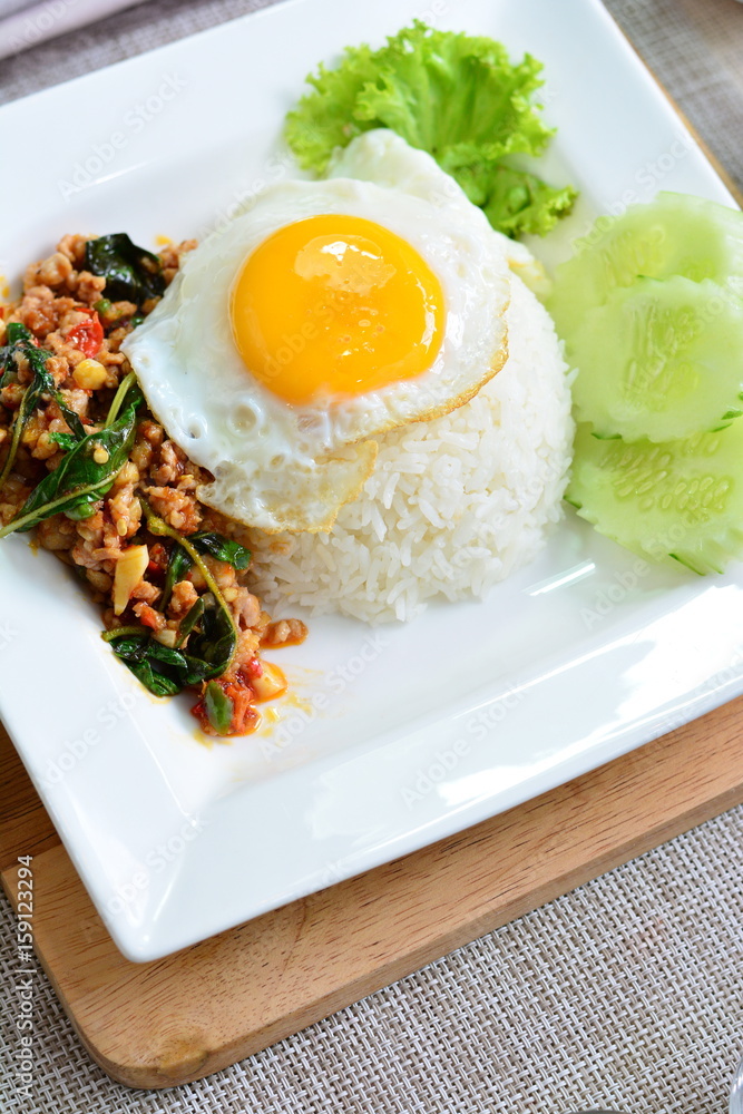 Stir fried minced chicken with basil, fried egg on rice Stir fried minced chicken with basil, fried egg on rice