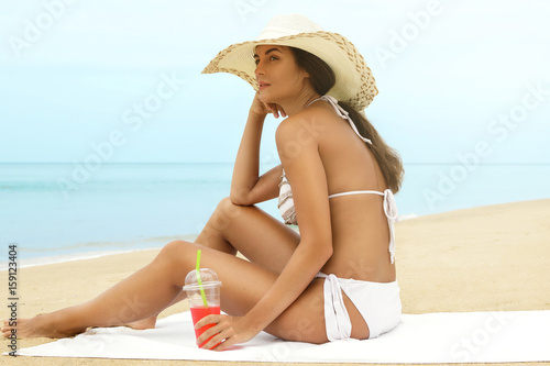 Happy woman relaxing on the beach