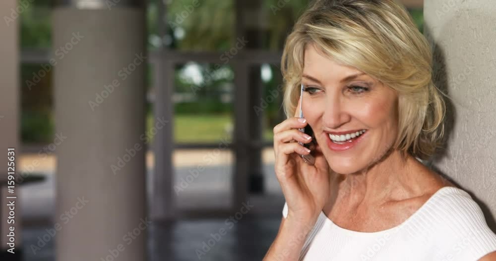 Happy executive talking on mobile phone Happy executive talking on mobile phone
