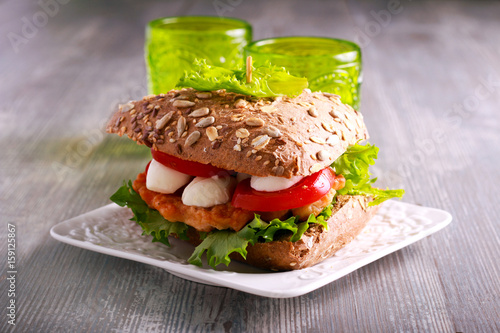 Salmon, mozzarella and tomato brown sandwich