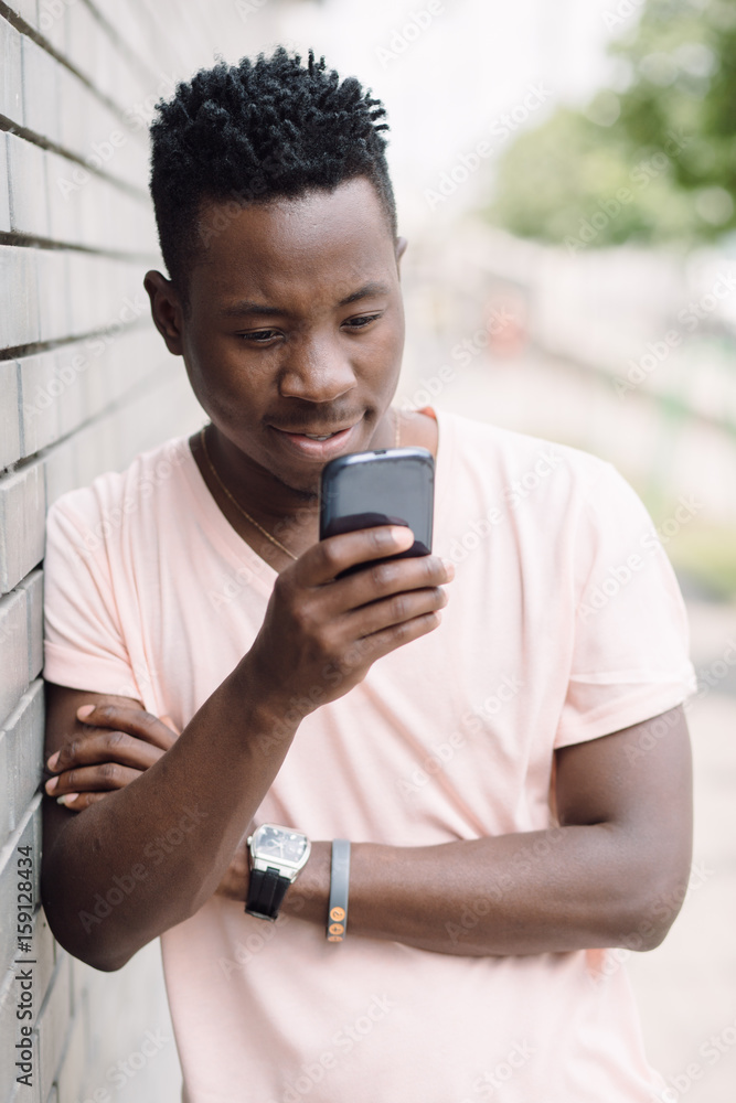 African american man using cellphone in summer city African american man using cellphone in summer city
