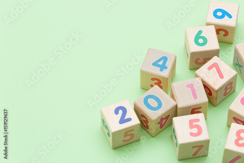 Wooden cubes with numbers on light green background