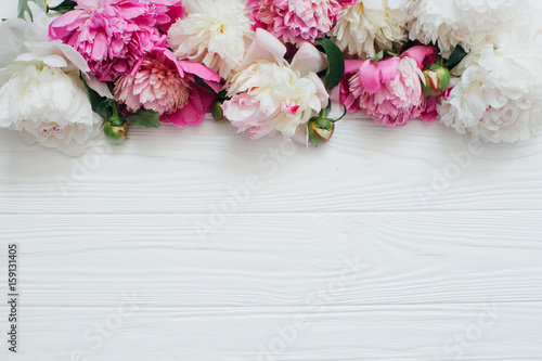 Fotografie, Obraz White and pink peonies on a wooden background.