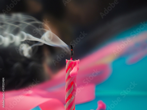 Fényképezés birthday candles that have just been blown out with smoke on color background