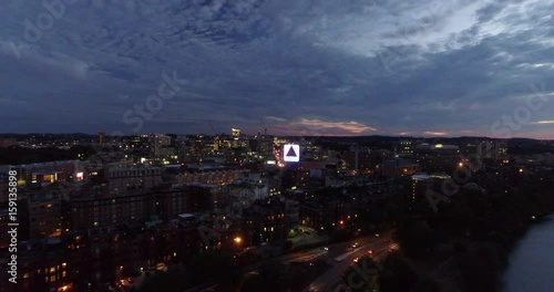 Backwards aerial shot of Fenway Citgo Sign in twilight Boston over Charles River photo
